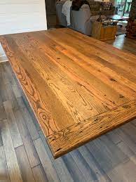 The wooden tabletop features natural markings from its previous use, giving you character and charm. Reclaimed Oak Dining Table Johnson Company Woodworking Johnson Company Woodworking