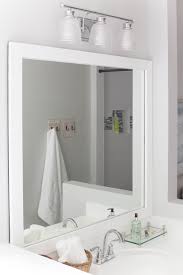 I used tape to hold it in place while it dried. How To Frame A Bathroom Mirror Budget Friendly Diy Project