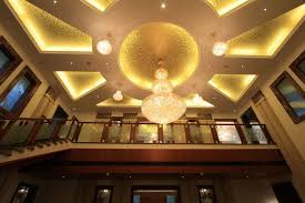 Double Height Ceiling In The Living Area Is Designed In Geometric Pattern False Ceiling With Gold Foil Effect An Ceiling Lights Light Decorations False Ceiling