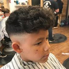 The sides are slightly shorter, and the top shows off the curls: 28 Coolest Boys Haircuts For School In 2020