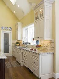 Kitchen Design Pairing Yellow Walls With Marble Countertops And Hardwood Flooring Yellow Kitchen Designs Yellow Kitchen Walls Kitchen Color Yellow