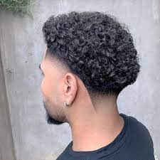 S curls make a dramatic contrast when accompany with taper fade sides, line up hairline and faded beard. Curly Hair Fade Haircut 7 Cool Styles For 2021 Curly Hair Fade Taper Fade Curly Hair Faded Hair