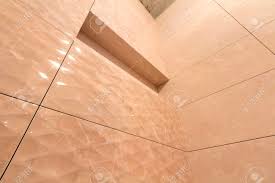 Bathroom floor tiles create your dream bathroom with our range of bathroom floor tiles. Angled View Of Bathroom Or Toilet With Light Beige Geometric Mosaic Ceramic Tiles Installed On Walls And Cement Ceiling Construction Reconstruction And Tiling Concept Stock Photo Picture And Royalty Free Image Image