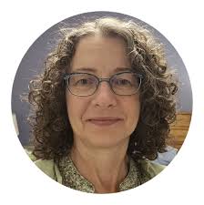 What fruit is growing by the pea fence water tote?