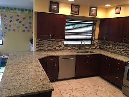 Giallo ornamental is a granite with hues of gold, brown, and cream minerals patterned throughout the surface. Giallo Ornamental Granite Countertops In Kitchen With Backsplash Tiles