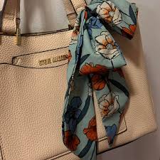 Cream colored Steve Madden bag with floral scarf....