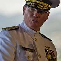 Capt. Travis Rasmussen gives remarks at a change of