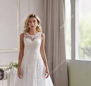 The Soft Tulle A-Line Wedding Dress Has An Illusion Neckline And Sheer Back