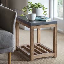 Stella's warm nutmeg wood finish and sturdy metal base will complement any living room decor. 16 Small Side Tables Perfect For Compact Spaces