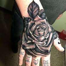 A tattoo design that has a clock with no hands and a rose symbolizes endless love. Top 101 Best Rose Hand Tattoo Ideas 2021 Inspiration Guide