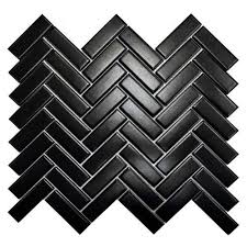 This bathroom's tight and seamless grout lines make the black herringbone floor tile plays a beautiful balancing act with the shower's articulated white subway tile. Festivalmatte Black Herringbone Porcelain Mosaic Porcelain Mosaic Black Herringbone Floor Decor