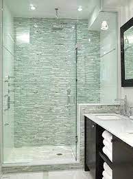 A small bathroom with a shower separate with white long tiles, a printed tile floor, a potted plant and a white vanity a small bathroom with grey long tiles and printed ones on the floor, a graphite grey vanity, touches of gold and a marble countertop Small Bathroom Ideas With Shower Only Google Search Bathroom Design Ensuite Design Beautiful Bathrooms
