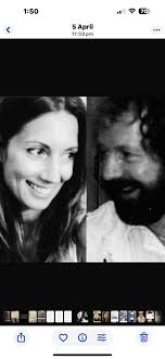 Can you make this photo look like they are looking at each other sat side  by side please