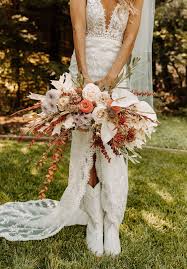Beautiful ceremony decor ideas in western style. Bridal Cowboy Boots Boho Wedding Flowers Wedding Bouquet Ideas Bay Area Wedding Photograp Peach Pink Wedding Boho Wedding Flowers Flower Bouquet Wedding