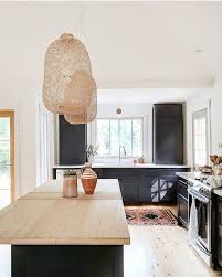 Black And Light Wood Kitchen Cabinets Black Kitchen Cabinets With Light Wood Countertops And Rattan Pendant Lights Kitchen Interiorde Bohemian Kitchen Stylish Kitchen Design Kitchen Design Trends