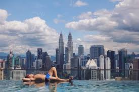 Check out all these options of where to stay to get access to the best pool! Man Relaxing By The Infinity Rooftop Pool In Kuala Lumpur Malaysia Stock Photo 710993b6 07f9 4ca5 Af37 E155a6aa8328