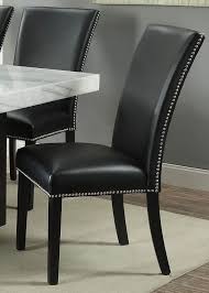 This chair has a sweeping shape and features a clarck gray upholstery, punctiliously deposited with antique brass nails. Steve Silver Dining Room Camila Black Pu Dining Chair With Nailhead Cm420skn Carol House