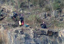 Shouldn't he be doing the rescuing? Mountain dog survives 100ft fall down  quarry... and two men who try to save him also become stranded