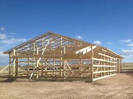 Barn plans include several design elements in their post frame basics: New 40x60 Shop Polebarn Being Erected Duramacks Structures