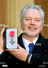 Conductor Neil Mantle holds his MBE outside Buckingham Palace after it was  presented to him by the Prince of Wales Stock Photo