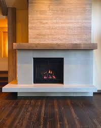 This is an example of modern fireplace ideas that create a stunning monochromatic effect when paired with similar shades of wood furnishings. Top 50 Best Gas Fireplace Designs Modern Hearth Ideas