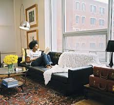 Black And Gold Leather Couch Black Leather Sofa Persian Rug Mid Century Lamp Wall Art In Gold Frames Vintage Suitcas Black Leather Sofa Living Room Black Sofa Decor Rugs In Living Room