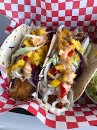 Crispy, spicy fish tucked into a bed of crunchy, sweet, and sour red cabbage slaw, all piled high on a tortilla—just add ice cold drinks and lots of laughter for a party. Fish Tacos 2 Soft Shell Tacos With Beer Battered Cod Shredded Cabbage Topped With Fresh Mango Salsa And Drizzled With A Spicy Aioli Served With Chips And Guacamole Picture Of Schooner