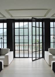 A Grid Of Black Steel Doors Leading To Waterfront Balcony Anouska Temple Design House Design Home French Doors Interior