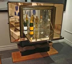 Stunning condition vitrine with three drawers on the bottom standing on tapered legs with brass accents. Vittorio Valabrega Rare Bar Cabinet Studio Van Den Akker