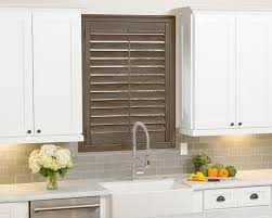 When choosing window treatments for your kitchen, you have more than just the style to consider. Kitchen Plantation Shutters Behind Sink By Skyline Window Coverings Skyline Window Coverings