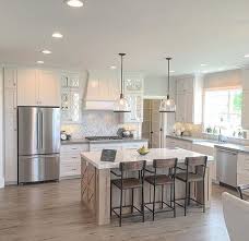 Simple And Open Kitchen Plenty Of Space Between The Island And The Perimeter Cabinets A Window Over Th Interior Design Kitchen Kitchen Remodel Kitchen Layout