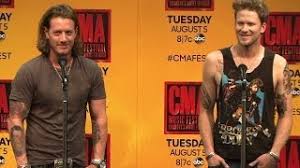 The tattoo shows a skeleton biker riding a motorcycle with the. Florida Georgia Line New Tattoos At Cma Fest Youtube