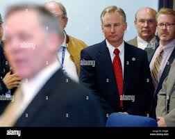 Special prosecutor Don Quick, back, looks