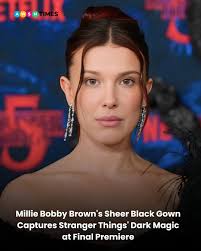 Millie Bobby Brown made a stunning statement at the Stranger Things 5 world  premiere with a gothic-inspired sheer black Rodarte gown, blending metallic  lace, feathers, and tulle that perfectly echoes the show's