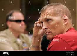 John Crabtree, left, a senior chief in the navy, and marine Lt. Col. Tim  Maxwell listen to the presentation during a peer support session at the  Blinded Veterans Association annual conference in