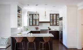 A farmhouse sink and deck mount faucet stands under a picture window next to a corner glass door which leads to the backyard. 200 Beautiful White Kitchen Design Ideas That Never Goes Out Of Style Peninsula Kitchen Design Kitchen Designs Layout Kitchen Layout