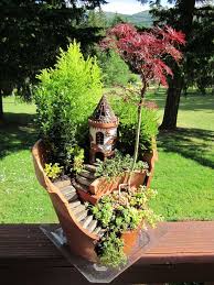 Rocks make the base for this fairy garden in an old wood bucket. 40 Magical Diy Fairy Garden Ideas