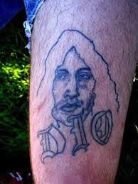 A bright and radiant tattoo for ronnie james dio with his famous hand symbol. Ronnie James Dio Tattoo