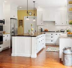Wooden chair and floor accentuate the warm tone of the island. Farmhouse Kitchen With Butcher Block Island Klassisch Kuche Burlington Von Bickford Construction Corporation Houzz