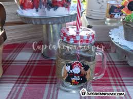 A simple glass vase with a white candle raises from the center, surrounded by live annuals for a touch of color and nature. Barnyard Party Ideas Eli S Farm Birthday Party Cupcakemakeover
