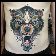 Awesome grey ink wolf head and dreamcatcher tattoo on shoulder. 101 Meaningful Wolf Tattoo Designs