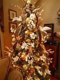 Christmas Tree Filled With White Poinsettias Gold Trumpets And Cherubs Bro Christmas Tree Decorating Themes Christmas Tree Ribbon Garland Holiday Wreaths Diy