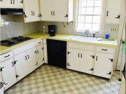 After sanding the walls, we painted the kitchen walls with some of the living room's paint. 1960 S Kitchen Gets A Dramatic Makeover 1960s Kitchen Remodel Kitchen Flooring Kitchen Cabinets Makeover