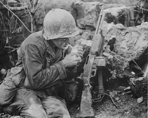 A Lone Sniper — Iwo Jima, 1945 📸 Marine Scout Sniper with Unertl-equipped  Rifle He is unnamed. Unidentified. But unmistakable. Captured in a rare  photo from the black sands of Iwo Jima,