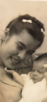 This is my mommy holding me in her arm . She was nineteen years old at this  time and sixteenth months later at the age of twenty she passed away  leaving me