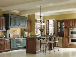 We Love The Pop Of Color From The Turquoise Rust Hawthorne Cabinets Surrounded In Mink In This Decora Cabinets Turquoise Cabinets Contrasting Kitchen Cabinets