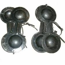 Often castanets a percussion instrument consisting of a pair of slightly concave shells of ivory or hardwood, held in the palm of the hand by a connecting cord over the thumb and clapped together with the fingers. Castanets Definition
