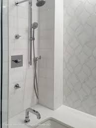 The small tiles on the floor and rectangular tiles on the vanities backsplash tie the gray marble into the mostly white space, while bold black mirrors break up the neutral hues. Modern Bathroom Remodel Ideas Creative Interiors Designs Hoboken Nj