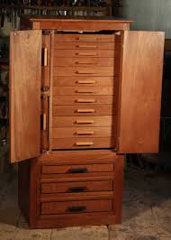 The most common double door armoire material is glass. Koa Jewelry Cabinet With Necklace And Earring Storage