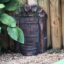 A fairy garden actually has fairy in its name and that immediately suggests something whimsical and magical. Fairy Door For Your Garden Large Hobbit Tree Door Candle And Blue